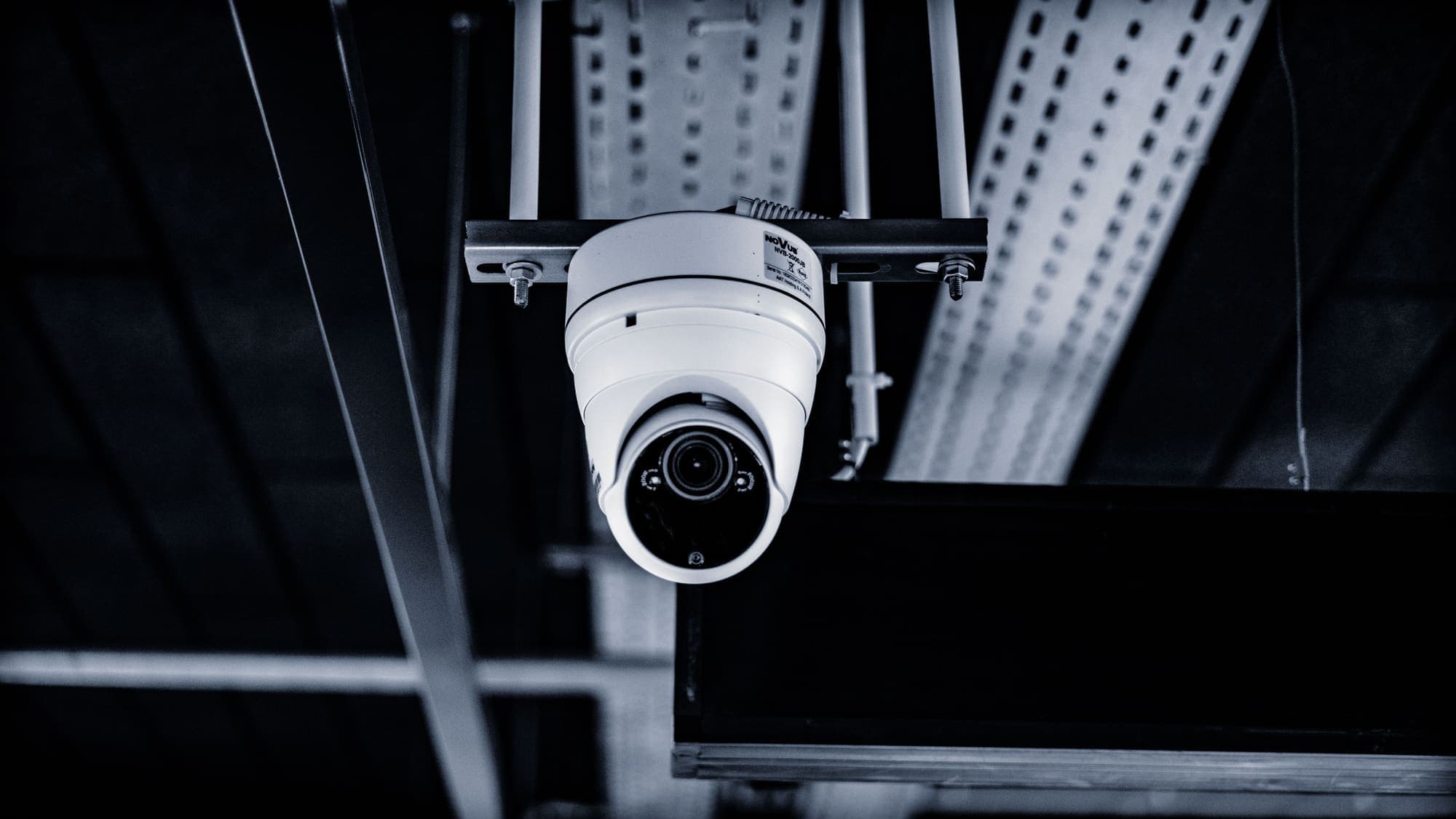 Dome surveillance camera mounted on a ceiling structure